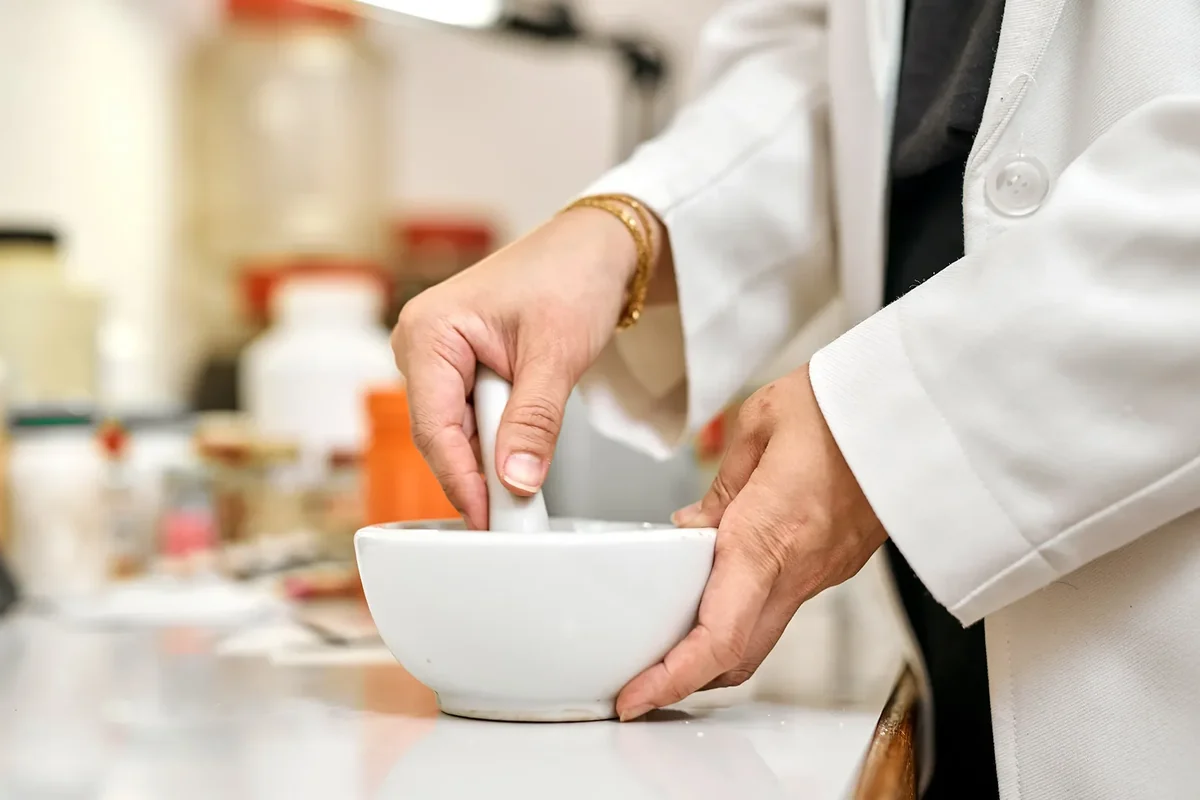 Pharmacist compounding custom medication, representing service-specific pharmacy SEO content